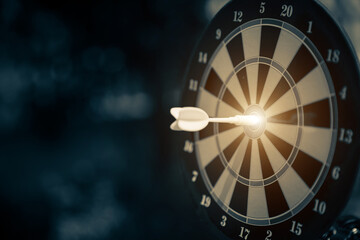 Bullseye target goal or dartboard has dart arrow throw hitting center shooting for strategy organization management of financial business targeting planning to winner concept.