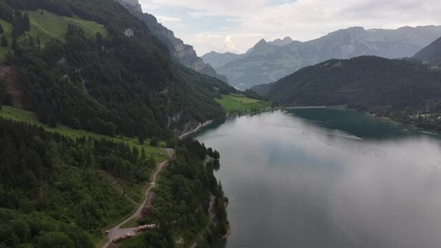 Kl&ouml;ntalersee, Vordergl&auml;rnisch, Glarus, Switzerland - A Stunning Vista of a Lake Bordered by Verdant, Mountainous Landscape - Aerial Pullback Shot