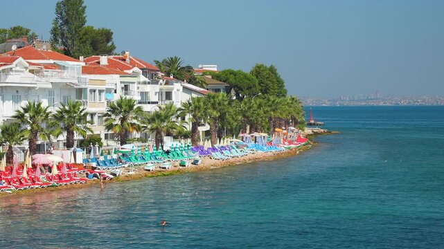 Kinaliada Port Beach and the panoramic Istanbul city skyline far away on the horizon. View from the ferry in the Sea of Marmara. Summer vacation in Turkey