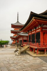 Beautiful dawn of Kiyomizu-dera Temple in Kyoto, Japan, with lush green trees and a clear sky.