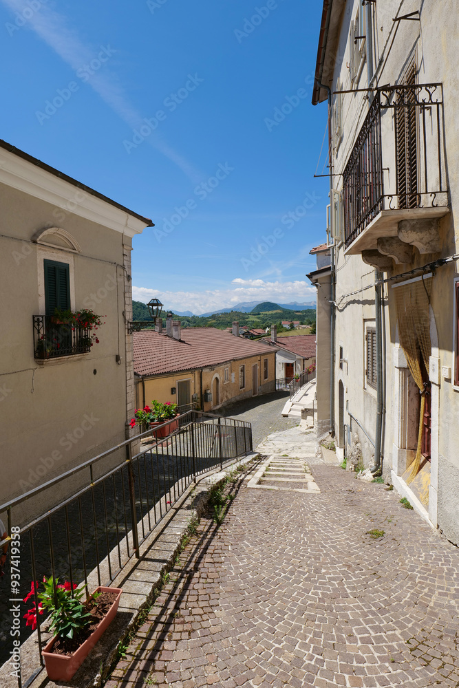 Poster A street between old houses in Vastogirardi, a village in Molise in Italy.