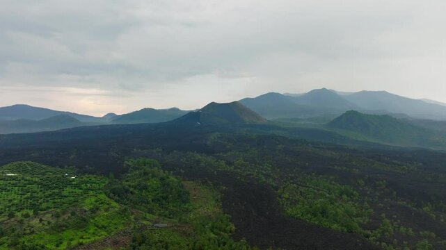 DRONE: DOLLY OUT SHOT OF PARICUTIN VOLCANO IN A CLOUDY DAY AT MICHOACAN MEXICO