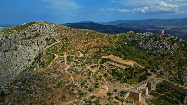 High angle shot of Acrocorinth castle with beautiful landscape at background under cloudy day in Greece.
