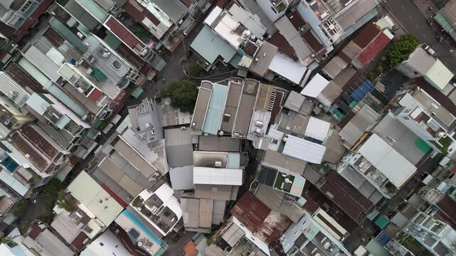 Ho Chi Min City, Vietnam District eight from top down aerial view featuring rooftops, dense urban housing, streets and alleyways. Camera rotates CCW
