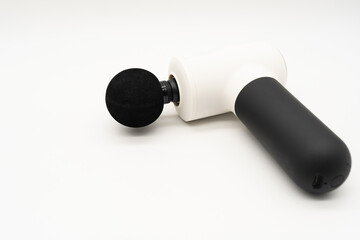 Modern massage gun for therapeutic muscle relaxation. percussion massager. copy space.