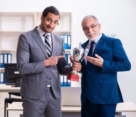 Two male employees working in the office