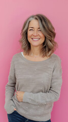 Fototapeta premium Smiling Middle-Aged Woman on Pink Background for Cancer Awareness 