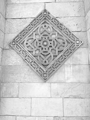 black and white photo of an extremely beautiful motif of Islamic architecture engraved in stone