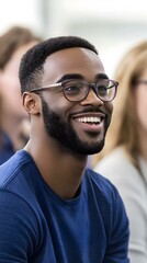 Obraz premium Smiling Man Wearing Glasses and Blue Shirt