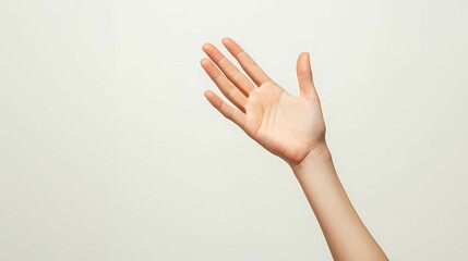A close-up of a raised hand against a neutral background, symbolizing greeting, communication, or a call for attention.