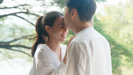 Young adult asia people fiance happy lover flirt fall in love nose lips kiss hug cuddle care trust....