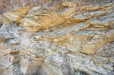 Background of mountain texture on Crete, Greece. Closeup on rocky, rugged cliff surface.
