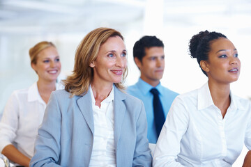 Fototapeta premium Business people, diversity and listening with corporate training, workshop and teamwork. Group, audience and employees with smile, cooperation and conference with collaboration, tradeshow and seminar