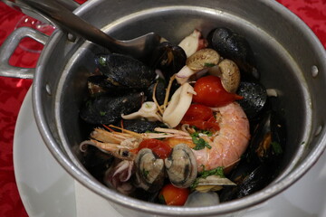 Italian cuisine: steamed seafood in white wine in Naples, Italy