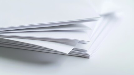 Stack of clean white paper sheets lying on desk