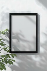 Fototapeta premium Black Frame Mockup With White Wall And Plant Shadow