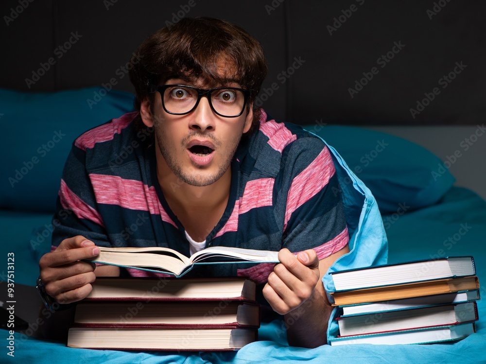 Wall mural young student preparing for exams at night at home