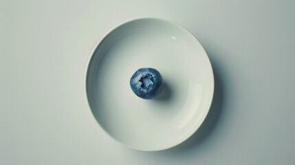 A classic still life painting featuring a single blueberry perched on a delicate porcelain plate, its simplicity