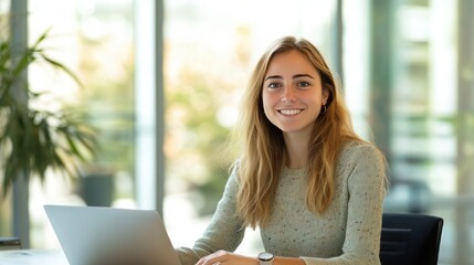 Business young smiling woman sitting in office and working on laptop