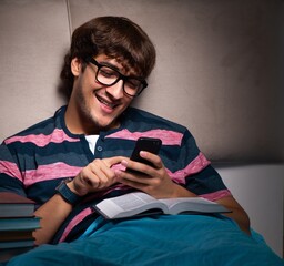 Young student preparing for exams at night at home
