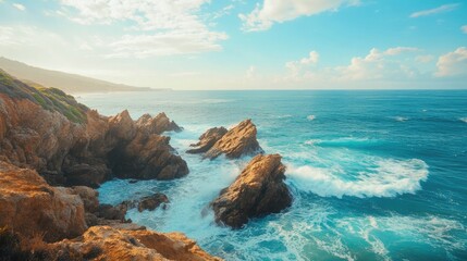 Picturesque coastline with rugged cliffs and turquoise waters, waves crashing against the rocks under a sunny sky.