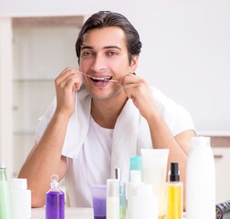 Young handsome man in the bathroom in hygiene concept