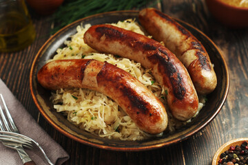 A bowl with Bratwurst and Sauerkraut as side dish - traditional German food