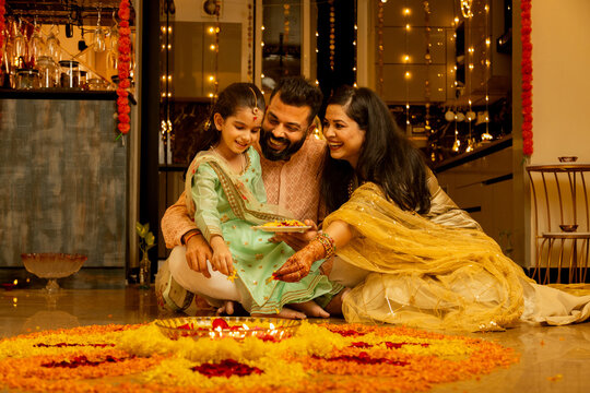 Happy Indian Family Celebrating Diwali at Home with Traditional Attire
