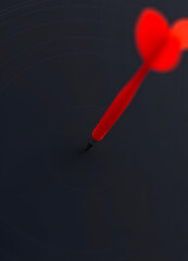 A red dart hitting the center of a target, surrounded by concentric circles on a dark background