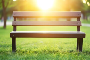 Fototapeta premium Empty Wooden Bench In A Green Grass Field At Sunset