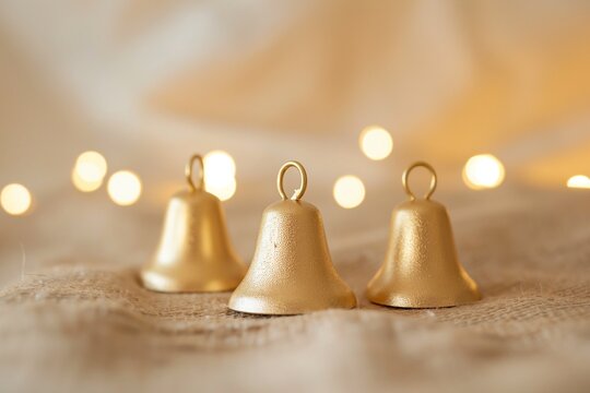 Gold bells on blurred light beige background