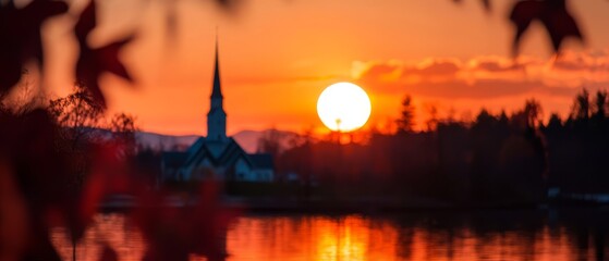  The sun sets over a tranquil lake, a church steeple distinguishing the horizon in the distance, while trees line the foreground