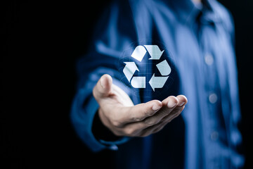 Circular economy concept. Businessman holding circular economy symbol on virtual screen. sustainable development growth business earning profit and environment reservation.