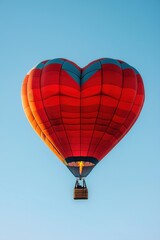 Fototapeta premium Red heart shaped hot air balloon flying in the sky