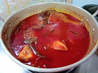 sour and spicy  is a Maritime Southeast Asian sour and spicy fish stew dish Close up of a bowl. photo taken in malaysia