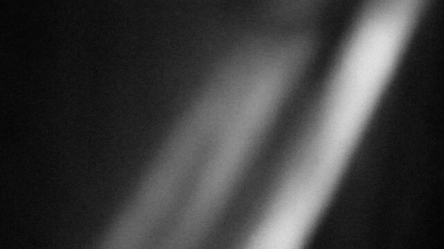Grunge noise texture with light leaks background 4K stop motion video. Blurred backdrop loop footage with grainy effect. Monochrome black and white overlay video