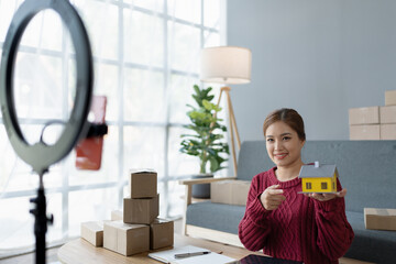 woman, online seller, uses live streaming to present items from her home, engaging with customers in real time to boost sales and showcase products