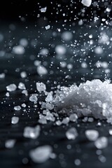 Fototapeta premium Macro shot of salt sprinkling onto a dark surface AI generated illustration