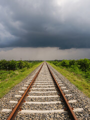Fototapeta premium railroad tracks in the countryside ai a cloudy day.