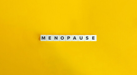 Menopause Word. Text on Block Letter Tiles on Yellow Background. Minimalist Aesthetics.