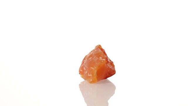 mineral stone carnelian rotates in a circle on a white background