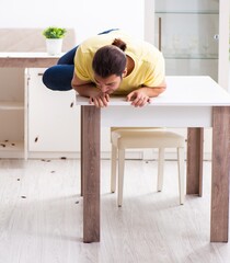 Young man and a lot of cockroaches at home