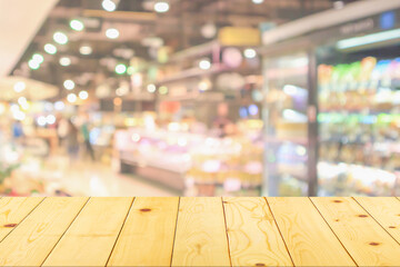 Empty wood table top with supermarket blurred background for product display