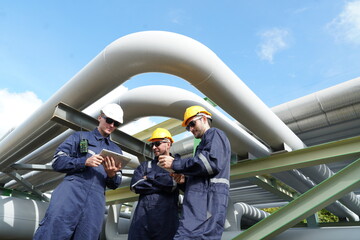 Male engineer in uniform holding tablet checking gas leakage pipe system and maintenance system and...