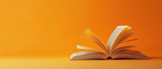 Close-up of an open book with career advice pages, orange isolated background, studio lighting