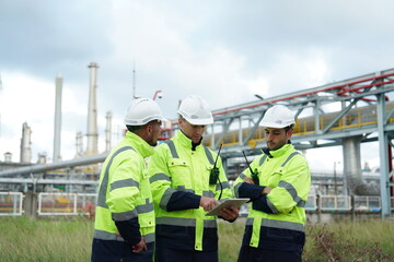 Chemical professional experts join hands with petrochemical plant engineers to work together as a team checking, maintenance, inspecting and examining to control the quality safety of oil, gas, refine