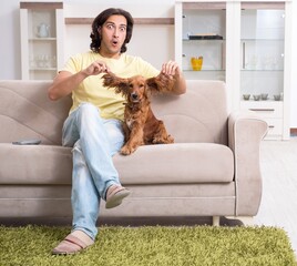 Young man with cocker spaniel dog