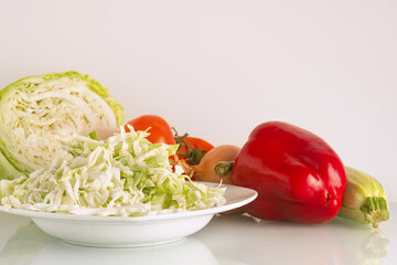 vegetables for salad or soup: tomato, cabbage, sweet pepper, zucchini and onion close up shallow depth of field