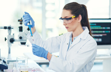 Scientist, experiment and woman with vial in laboratory for medical research, review or innovation....