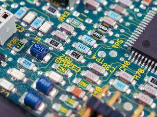 Close-up of ICs, chips, diodes and capacitors on a printed circuit board showing electronic component parts